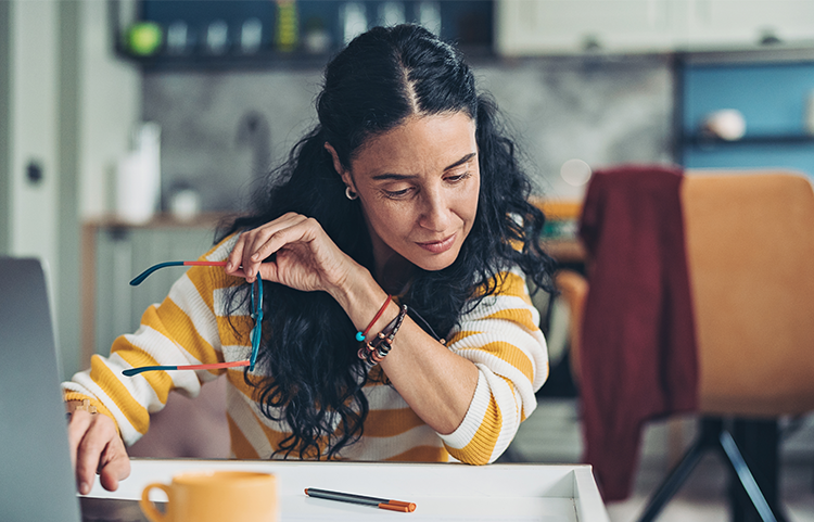 Woman looking over her finances on her computer.